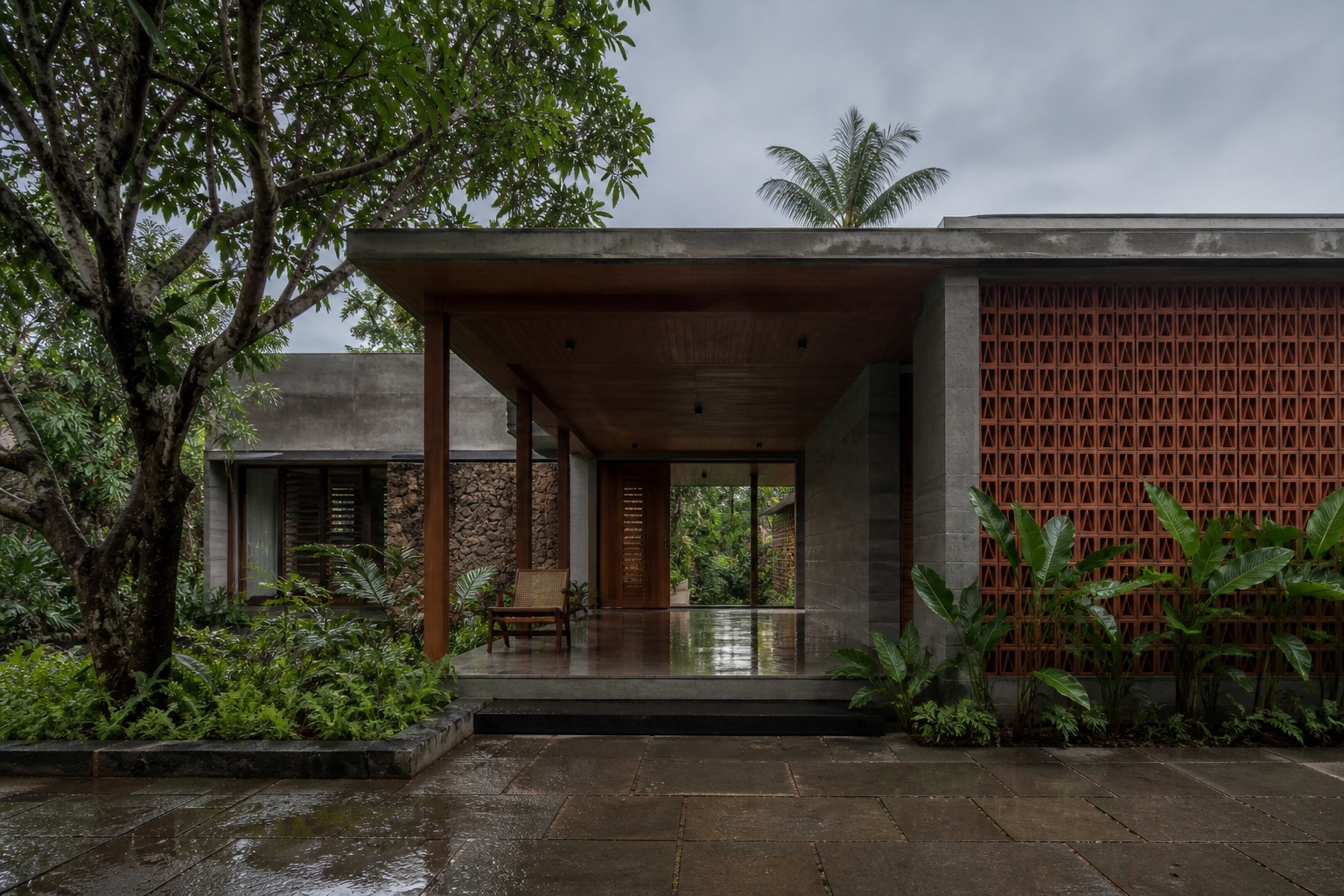 A climate-responsive house with a deep veranda and terracotta screen after rain