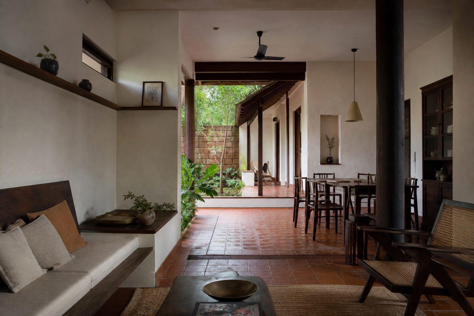 A lime-plaster and timber interior opens to a planted courtyard